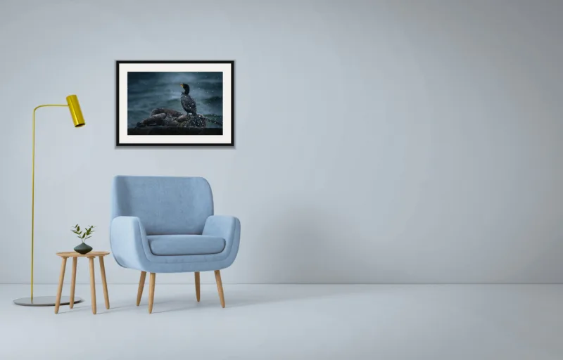 Sea spray shown framed as an A2 print, above a pale blue armchair on a grey wall