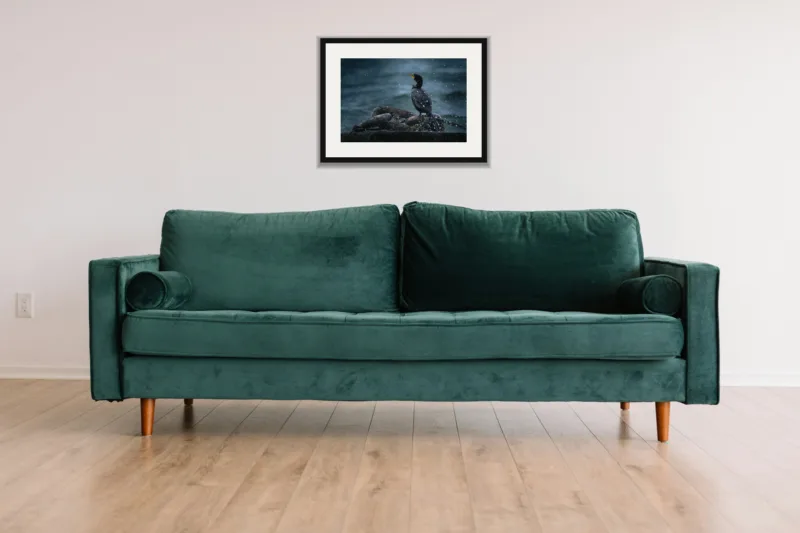 Sea spray shown framed as an A3 print, above a green velvet sofa against a white wall