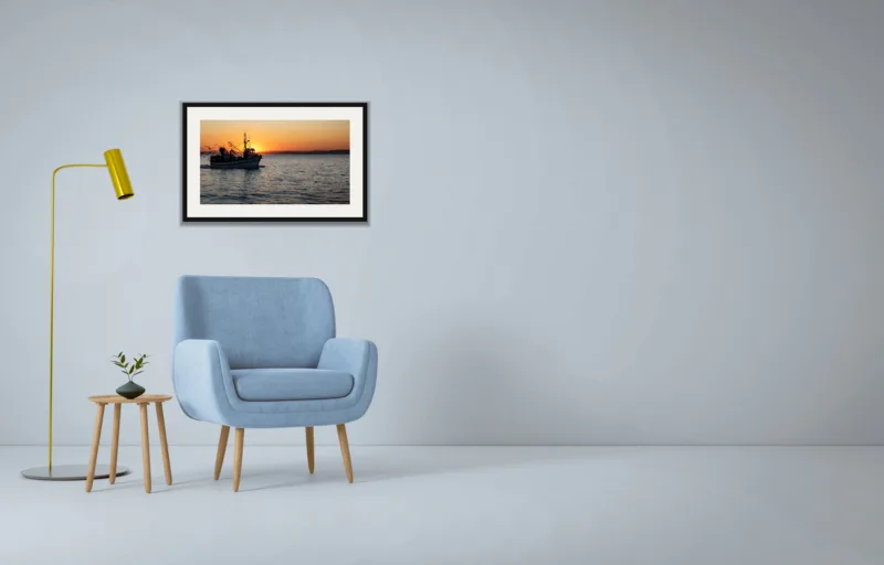 Homeward shown framed as an A2 print, above a pale blue armchair on a grey wall