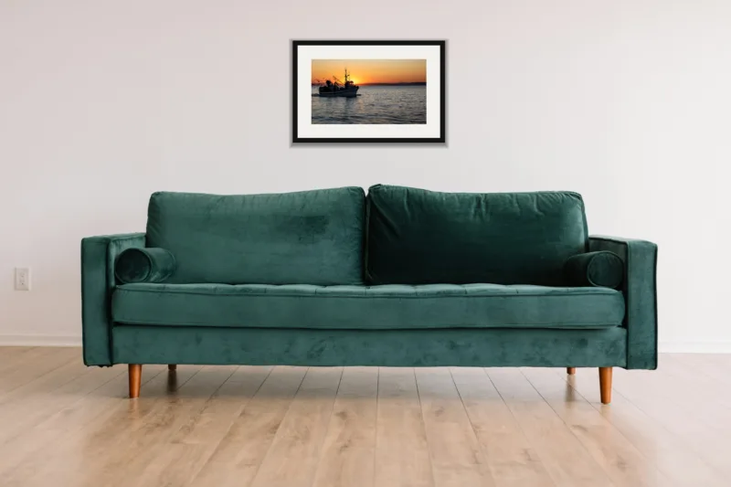 Homeward shown framed as an A3 print, above a green velvet sofa against a white wall