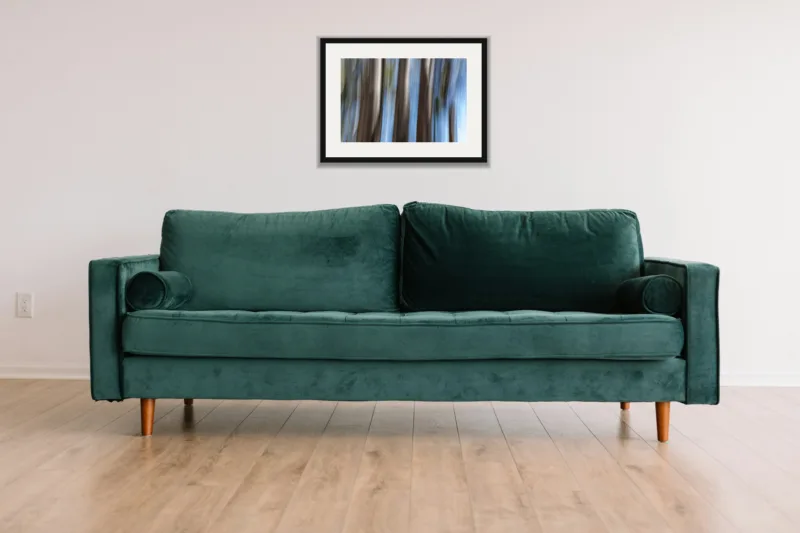 Forest dream II shown framed as an A3 print, above a green velvet sofa against a white wall