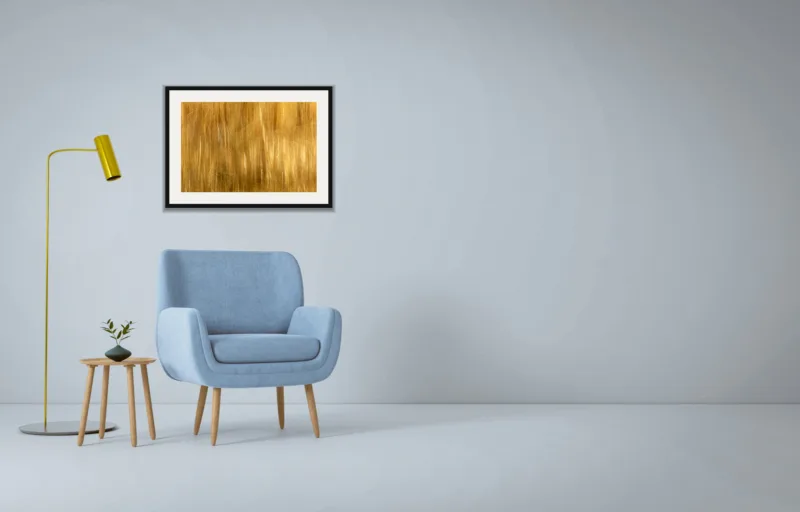 Forest dream IV shown framed as an A2 print, above a pale blue armchair on a grey wall