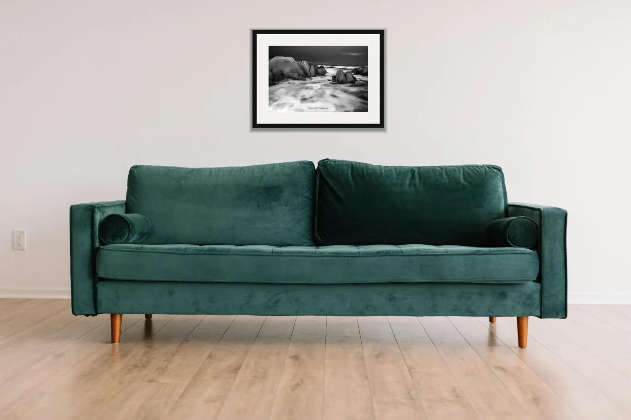 Granite and surf as a framed A3 print, above a green velvet sofa against a white wall