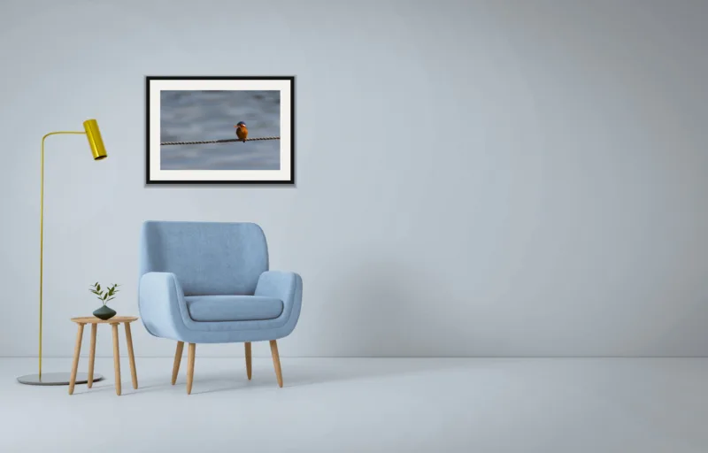 Tightrope shown framed as an A2 print, above a pale blue armchair on a grey wall