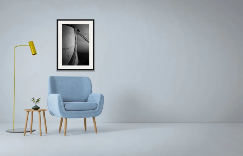 Moored shown framed as an A2 print, above a pale blue armchair on a grey wall