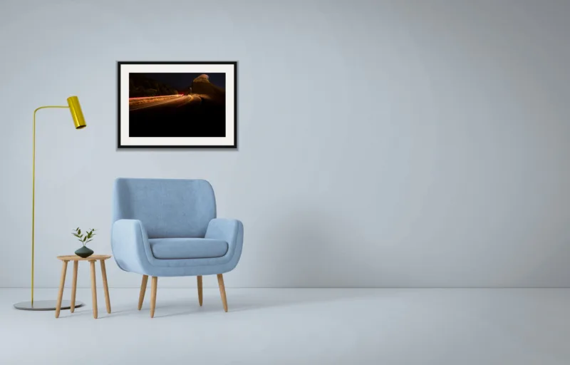 Night pass shown framed as an A2 print, above a pale blue armchair on a grey wall