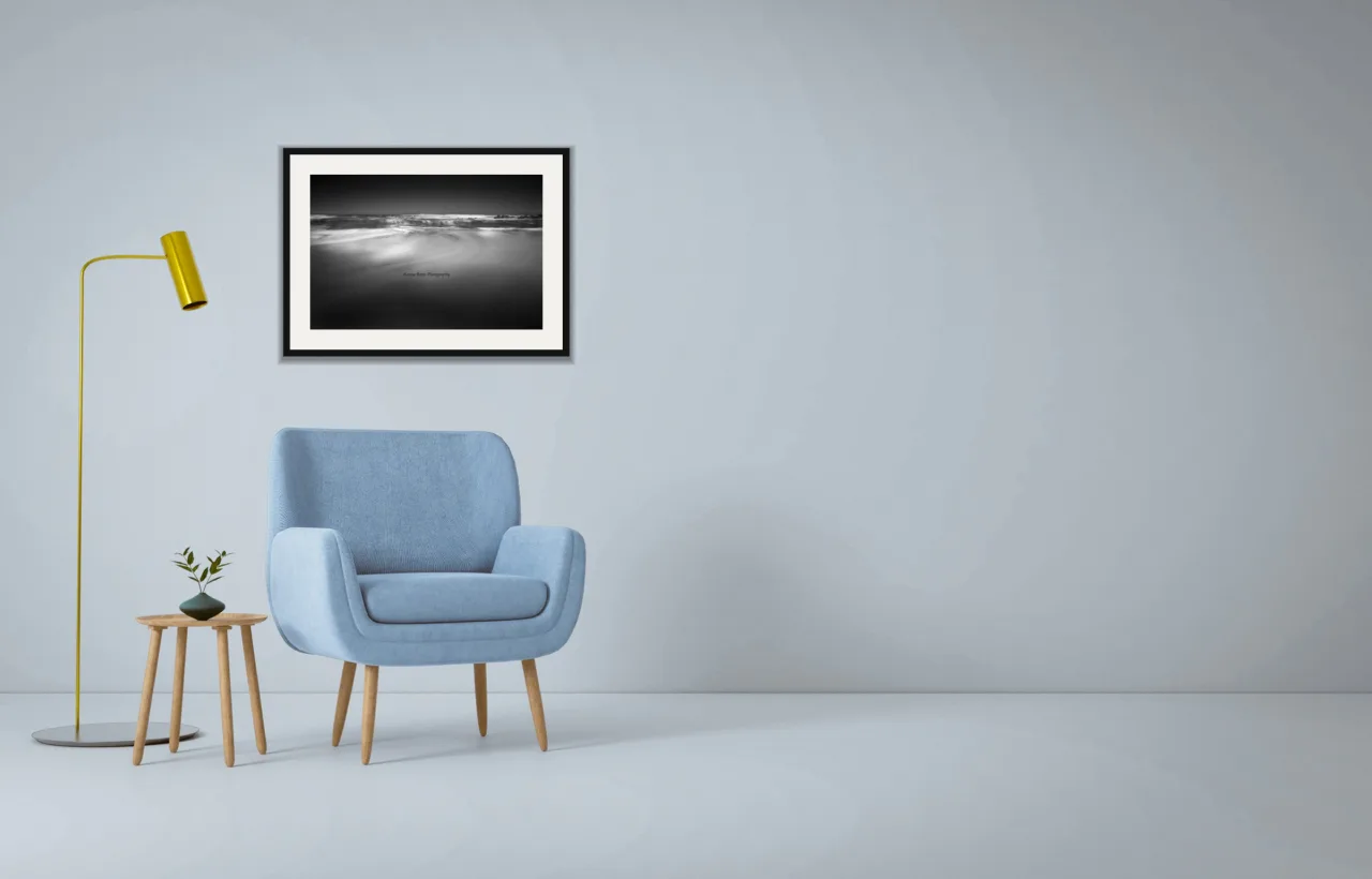 Tide line as a framed A2 print, above a pale blue armchair on a grey wall